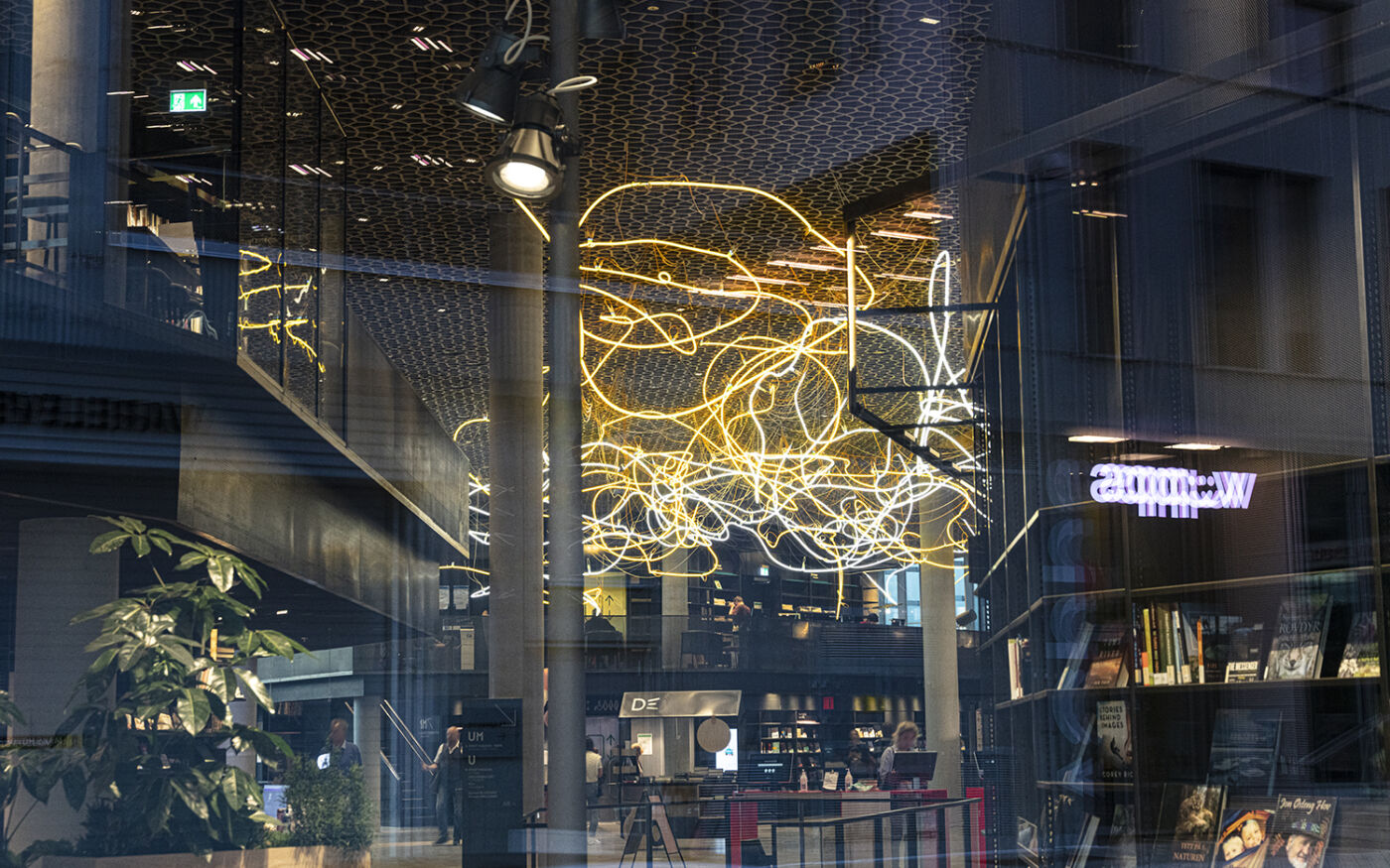 Deichman Bjørvika foaje med verk av Ramberg, kalt Brainstorm, tatt fra utsiden gjennom vindusflate. Foto