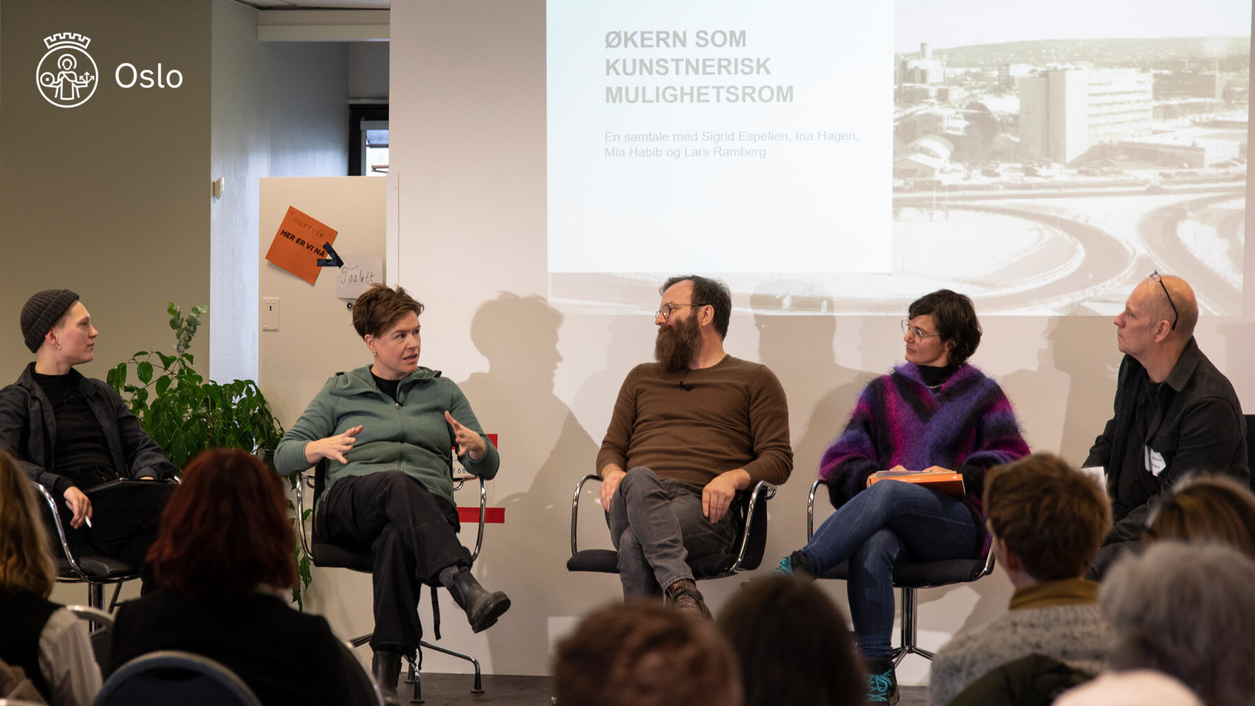 Foto av fem mennesker sittende på en scene. De diskuterer kunst til Hovinbyen, Økern.