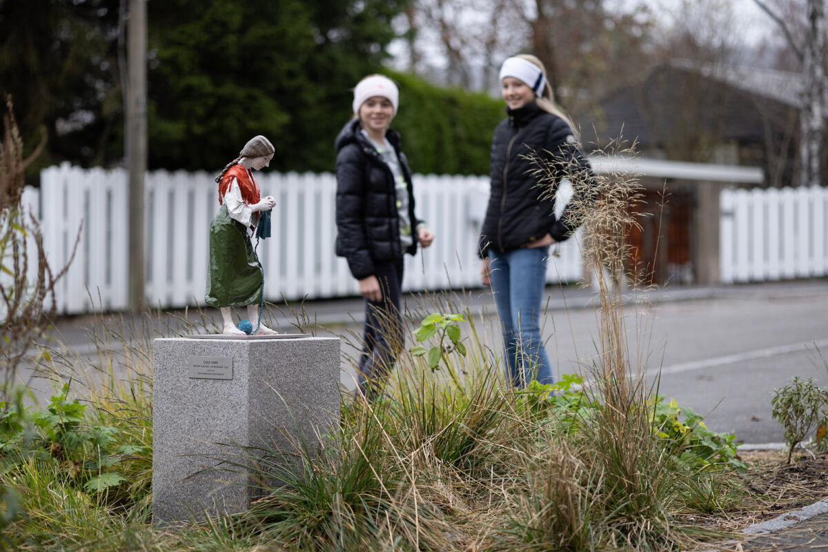 Foto av to elever som ser på en liten skulptur av operasanger Kirsten Flagstad.