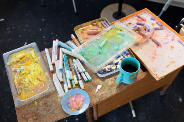 Detaljfoto av fargestifter på et bord i et studio.